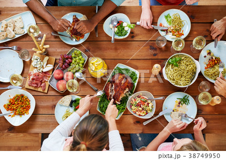 group of people eating chicken for dinner group of people eating chicken for dinner 38749950