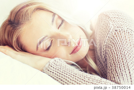 woman or teenage girl sleeping on pillow at home woman or teenage girl sleeping on pillow at home 38750014