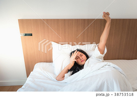 Asian woman waking up in bedroom Asian woman waking up in bedroom 38753518
