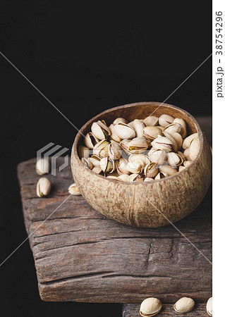 Pistachio nuts on the old wood Pistachio nuts on the old wood 38754296
