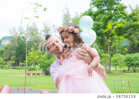 Father and his daughter playing together in park Father and his daughter playing together in park 38756159