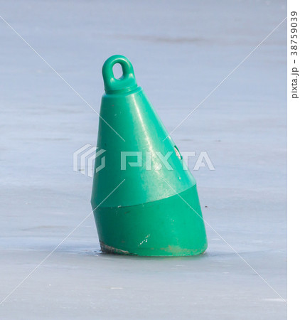 Green buoy in a large pond 38759039