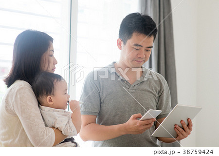 Asian family scanning QR code Asian family scanning QR code 38759424