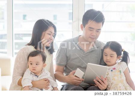 Asian family using tablet and smart phone Asian family using tablet and smart phone 38759426