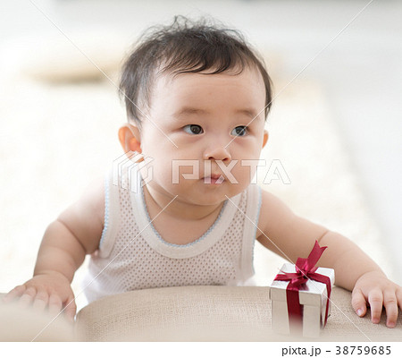 Baby learning to walk. 38759685