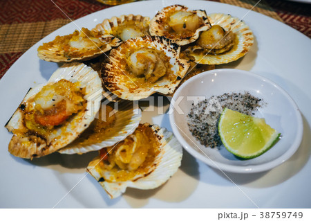 oysters with spicy sauce on a lime and salt plate 38759749