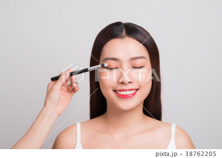 Young asian beautiful woman holding makeup brush 38762205