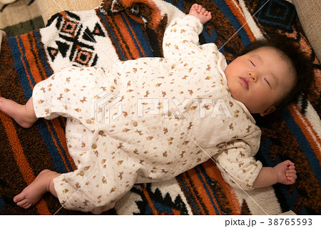 大の字で寝ている赤ちゃんの写真素材