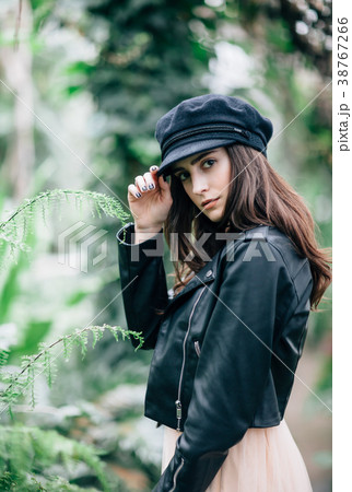 Fashion portrait of young stylish woman on nature background 38767266