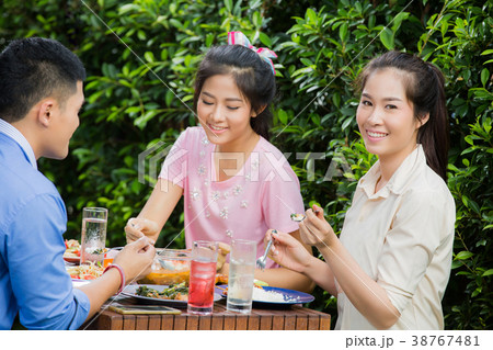 Asian women she was happily eating with friends Asian women she was happily eating with friends 38767481