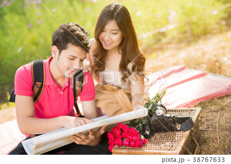 Tourists, men and women are looking at maps. Tourists, men and women are looking at maps. 38767633