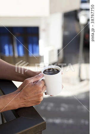 young man having a coffee in the balcony 38767750
