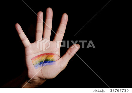 man with a rainbow flag in his hand 38767759