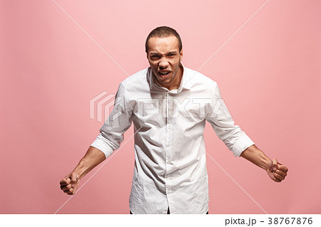 The young emotional angry man screaming on pink The young emotional angry man screaming on pink 38767876