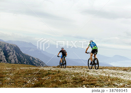 two cyclists mountainbiker two cyclists mountainbiker 38769345