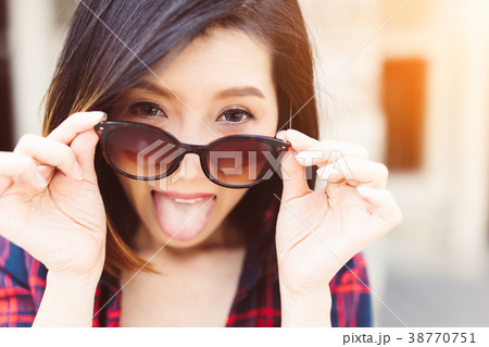 beautiful asian woman play with glasses  38770751