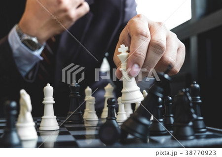 Close up of hands confident businessman colleagues playing chess Close up of hands confident businessman colleagues playing chess 38770923