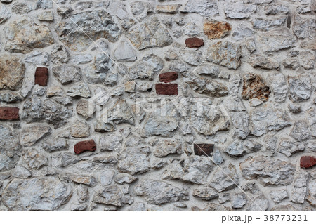 Old grey stone wall background texture close up. Old grey stone wall background texture close up. 38773231