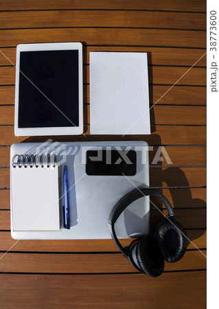 notepad with phone, laptop, headphones and tablet 38773600