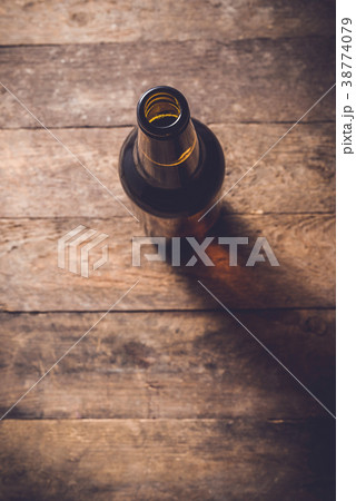 Beer bottle on an old wooden table. Top view Beer bottle on an old wooden table. Top view 38774079