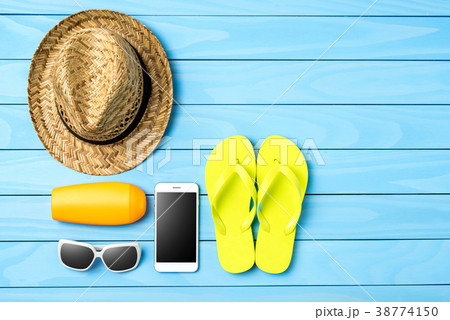 Beach or summer accessories on blue wooden table 38774150