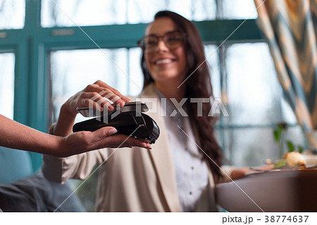 Happy attractive woman using nfc technology 38774637