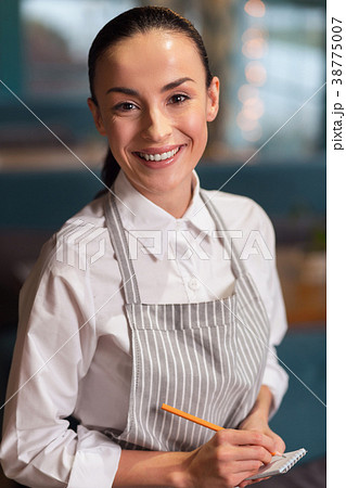 Skillful attractive waitress receiving order 38775007