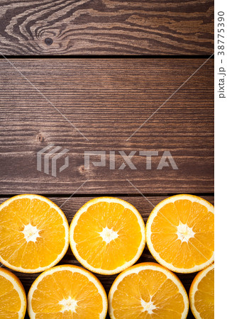 Half cut oranges on an old wooden table Half cut oranges on an old wooden table 38775390