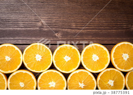 Half cut oranges on an old wooden table Half cut oranges on an old wooden table 38775391