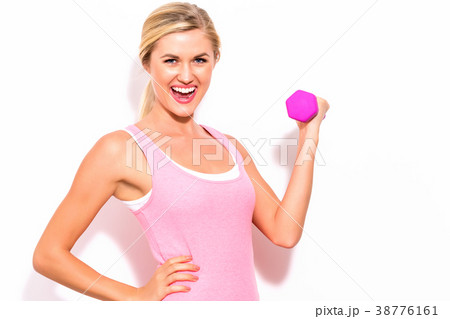 Woman working out with dumbbell Woman working out with dumbbell 38776161