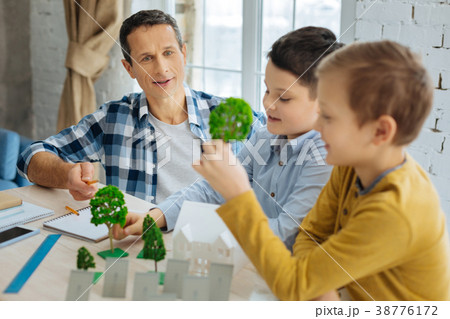 Young engineer telling his sons about landscape Young engineer telling his sons about landscape 38776172