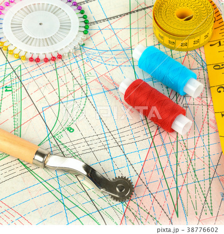 Background of sewing supplies and paper patterns. 38776602