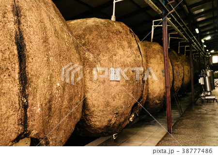 at the winery, large cylindrical barrels,  38777486