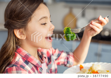 Content girl eating healthy vegetables for Content girl eating healthy vegetables for 38777490