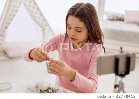 Pretty girl showing bag with rings while filming 38778418