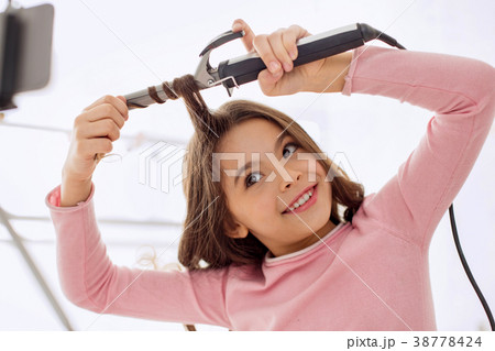 Pre-teen beauty vlogger curling her hair on camera 38778424