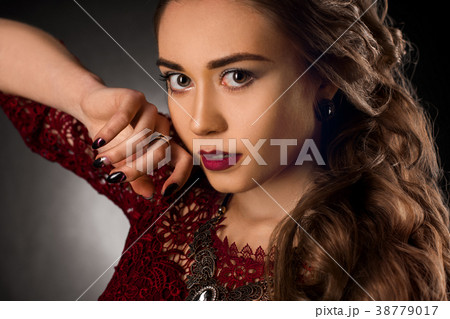 Charming young girl with beautiful curly hairstyle Charming young girl with beautiful curly hairstyle 38779017