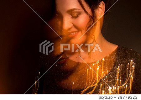 portrait of charming adult brunette in warm lights portrait of charming adult brunette in warm lights 38779525