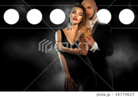 sexy young couple in black suit hugs and looks at sexy young couple in black suit hugs and looks at 38779625