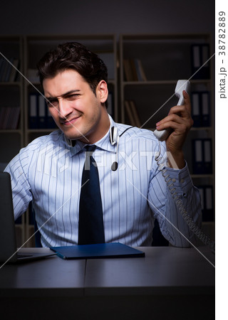 Tired and exhausted helpdesk operator during night 38782889