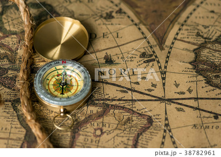 Old compass on vintage map with rope 38782961