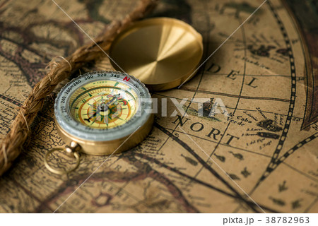 Old compass on vintage map with rope 38782963