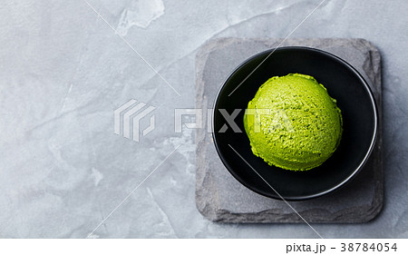 Green tea matcha ice cream scoop in bowl Top view. 38784054