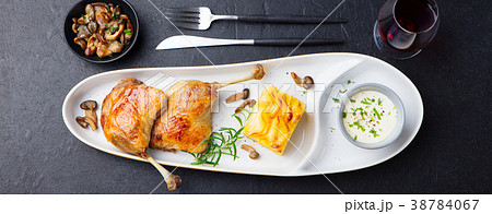 Duck legs confit, potato gratin and mushroom sauce 38784067