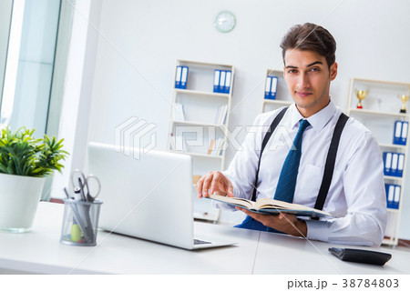 Young stylish businessman working in the office Young stylish businessman working in the office 38784803