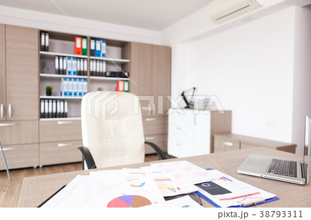 Table full of pappers in modern empty office 38793311