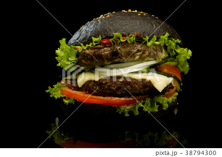 Black burger on a black background 38794300