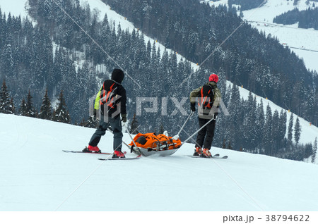 Ski patrol team rescue injured skier  Ski patrol team rescue injured skier  38794622