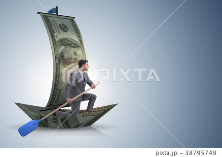 Businessman rowing on dollar boat in business Businessman rowing on dollar boat in business 38795749