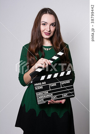 Young woman holding a movie clapper 38799442
